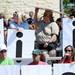 A volunteer uses her sign to shield the sun. Melanie Maxwell I AnnArbor.com